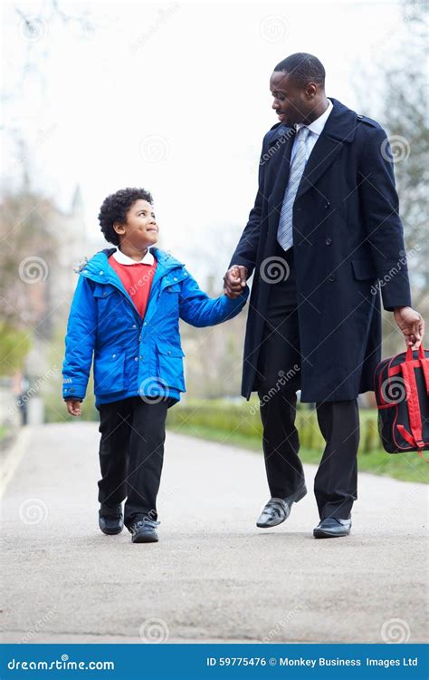 Father Walking Son To School Along Path Stock Photo - Image of hands ...