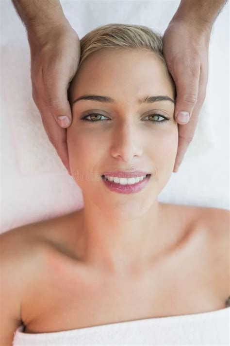 Attractive Woman Receiving Head Massage At Spa Center Stock Photo