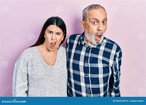 Hispanic Father And Daughter Wearing Casual Clothes In Shock Face Looking Skeptical And