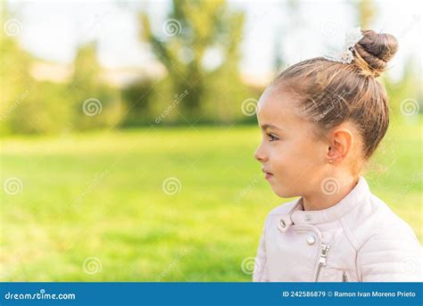 Side View Of A Little Girl Sitting On Grass Stock Image Image Of