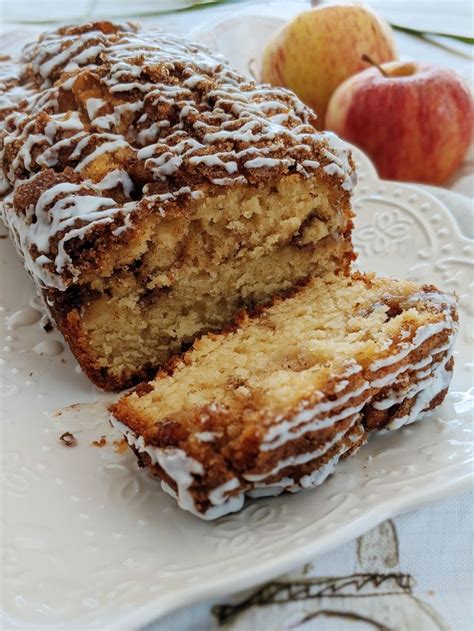 A Close Up Of A Cake On A Plate With An Apple In The Background