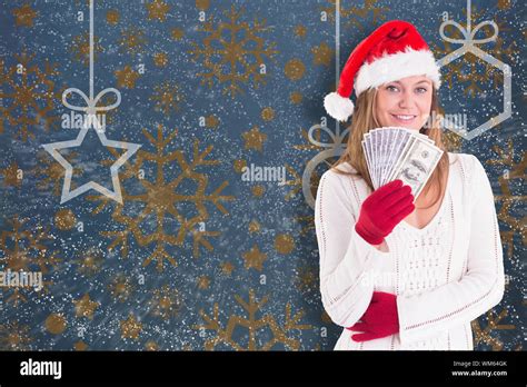 Festive Blonde Showing Fan Of Dollars Against Snowflake Wallpaper