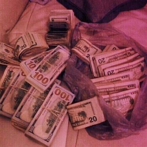 A Bag Full Of Money Sitting On Top Of A Bed Next To A Pile Of Cash