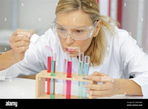 Mature Female Researcher Using A Pipette In Lab Stock Photo Alamy