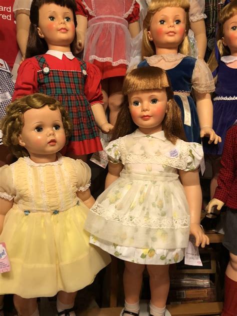 A Group Of Dolls Standing Next To Each Other