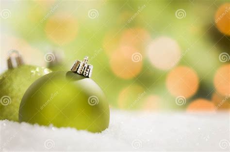 Pretty Green Christmas Ornaments On Snow Over An Abstract Background