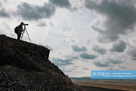 Chinese Male Photographer Taking Photos Outdoors High Res Stock Photo