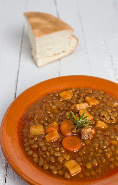 Premium Photo Stew Of Lentils With Chorizo And Pork