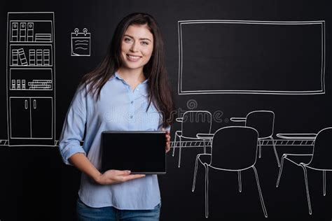 Cheerful Professional Teacher Standing In The Classroom Stock Image