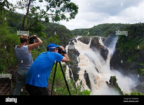 Couple photographing Barron Falls during the rainy season. Kuranda ...