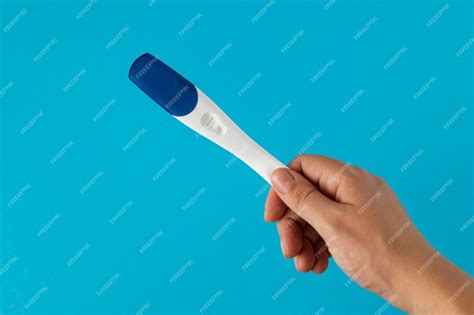 Premium Photo Hand Holding Positive Pregnancy Test