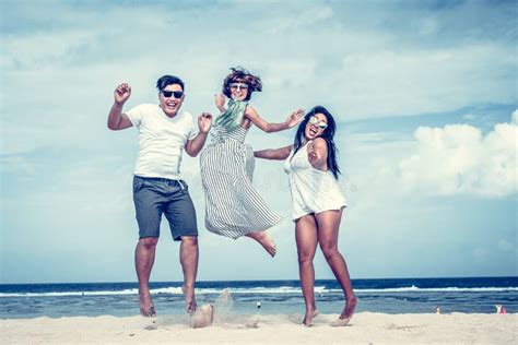 Group Of Multiracial Friends Having Fun On The Beach Of Tropical Bali