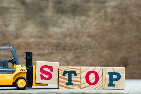 Yellow Toy Forklift Hold Letter Block S To Complete Word Stop Stock