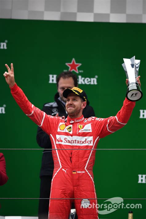 Sebastian Vettel Ferrari Celebrates On The Podium With The Trophy At