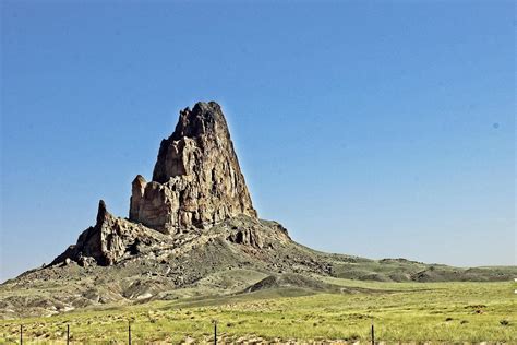 Lone Rock Formation Jutting Upward From Arizona High Desert 14285734