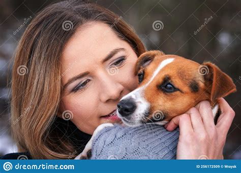 Young Woman Holding Her Jack Russell Terrier Dog Wearing Warm Winter