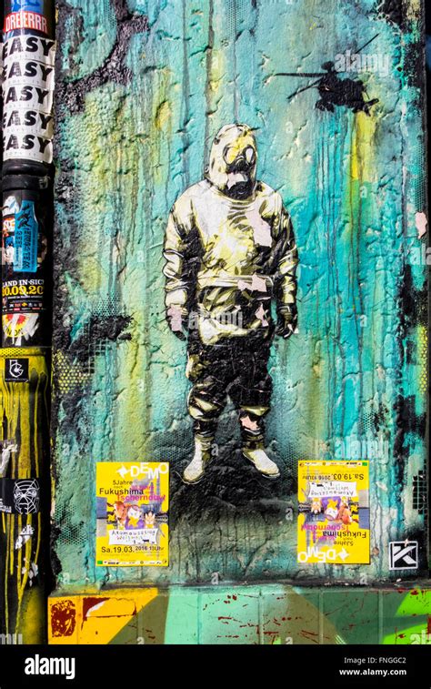 Street art, Graffiti. Man, gas mask, protective clothies and helicopter ...