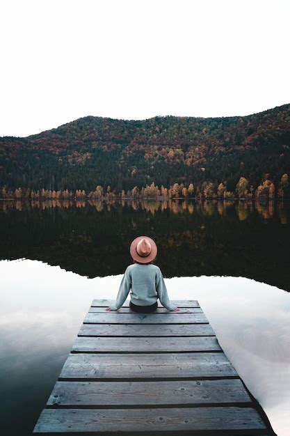 Premium Photo Rear View Of Woman Standing On Pier Over Lake