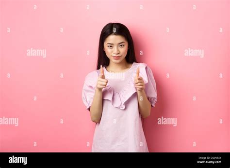 Sassy Asian Woman Pointing At Camera Smiling And Inviting You Beckon Or Praise Person