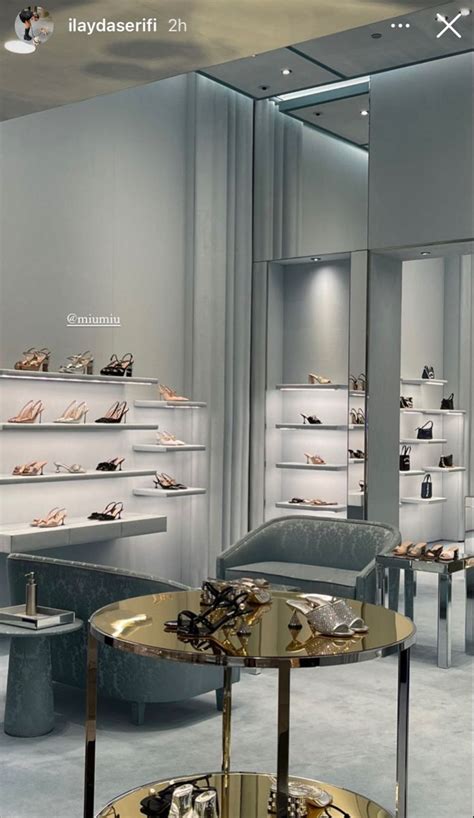 The Inside Of A Shoe Store With Glass Tables And Shelves Filled With