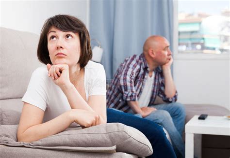 Upset Mature Woman After Quarrel With Husband At Home Interior Stock