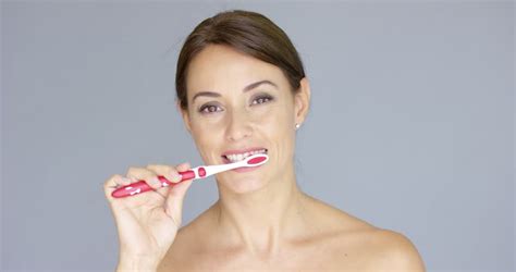 Attractive Woman Brushing Teeth Isolated On White Stock Footage Video