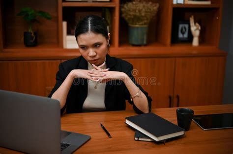 Thoughtful And Determined Asian Businesswoman Or Female Boss Looking At