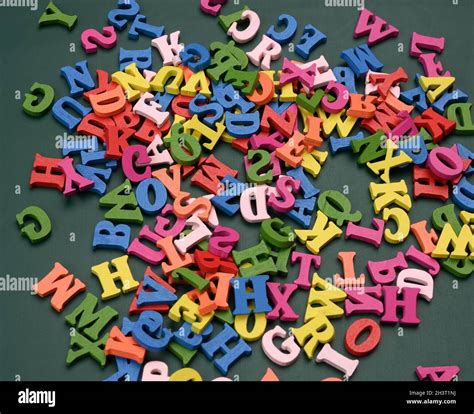 Multicolored Wooden Letters Of The English Alphabet On A Green