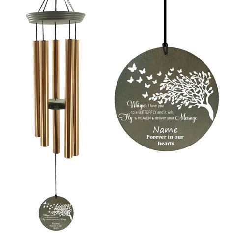 A Wind Chime With A Tree On It And A Memorial Plaque Hanging From The Front