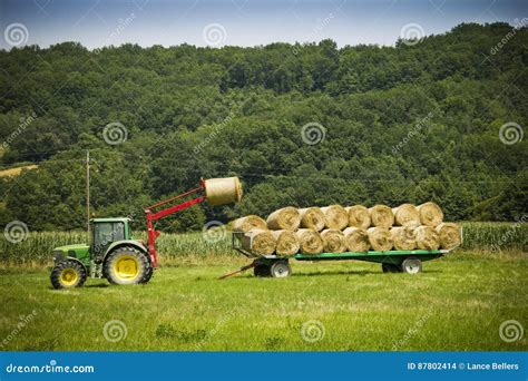 Tractor On Farm Loading Bales In Hay Onto Trailer Stock Photo Image