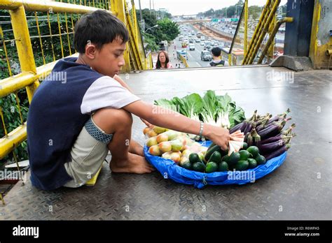 Child Labor In The Philippines Boy Selling Fruits And Vegetables On A