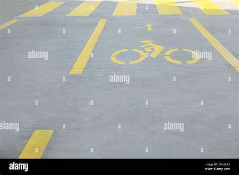 Bike Lane With Painted Yellow Bicycle Sign And Arrow Near Pedestrian