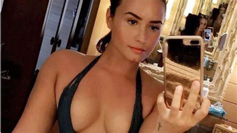 Demi Lovato Puts Ample Cleavage On Display In Plunging Swimsuit For