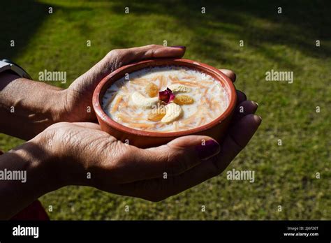 Female Holding Bowl Of Delicious Dessert From India And Pakistan Served