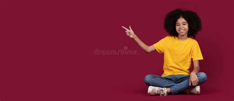 Happy African American Kid Girl Pointing At Copy Space Stock Image