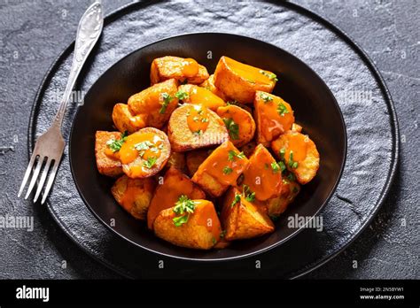 Patatas Bravas Deep Fried Potatoes With Spicy Sauce In Black Bowl On