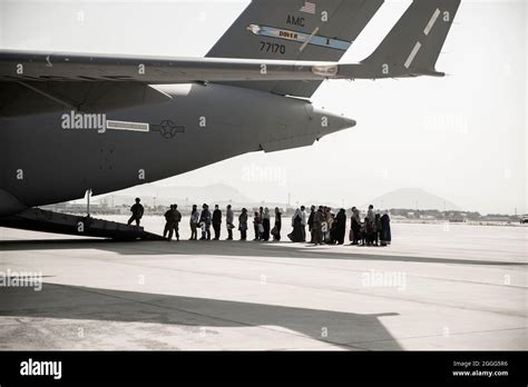 Evacuees Wait To Board A Boeing C 17 Globemaster Iii During An Evacuation At Hamid Karzai