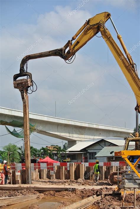 Retaining wall steel sheet pile installation by machine — Stock Photo ...