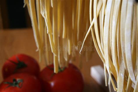 Handmade Fresh Pasta And Tomatoes Drying On Wooden Rack Italy