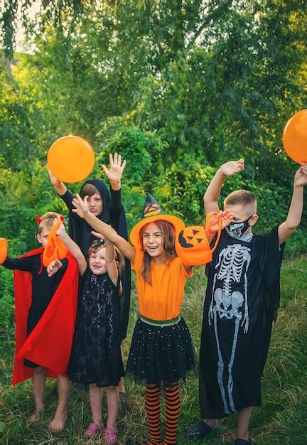 Premium Photo | Children celebrate halloween dressed up in costumes ...