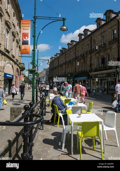 People Sitting Outside Café Area In Buxton Derbyshire England Stock