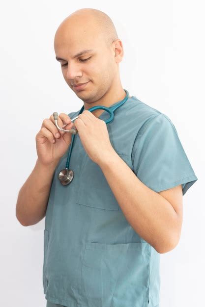 Premium Photo Bald Doctor Holding Stethoscope Against White Background