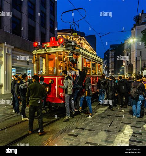 Famous Istanbul Red Tram Full Of People At Rush Hour In Istiklal Street