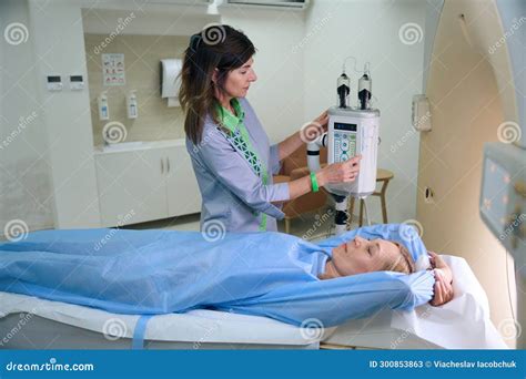 Radiologic Technologist Is Preparing Client For Contrast Ct Stock Image