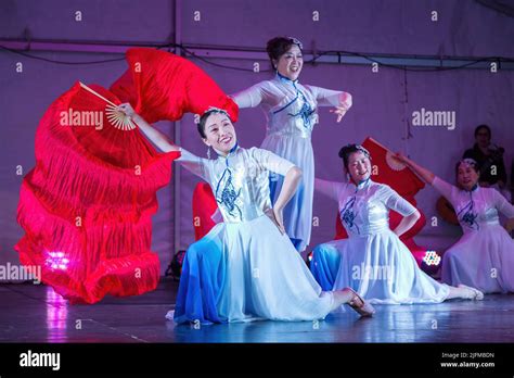 Chinese women in Cheongsam dresses performing a fan dance during Mid ...