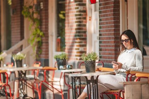 Premium Photo Woman Sitting On Table In Cafe