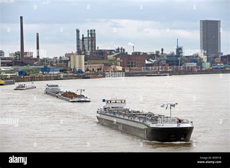 Commercial Barges Sailing On The River Rhine Past The Bayer Chemical