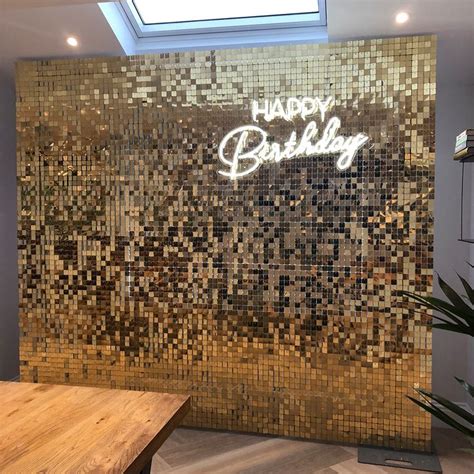 The Happy Birthday Sign Is Made Out Of Gold Mosaic Tiles