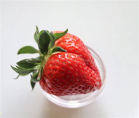 Strawberries With Leaves On A Plate In A Glas Bowl Isolated On A White