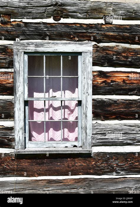 Detail of a window in a log cabin Stock Photo - Alamy